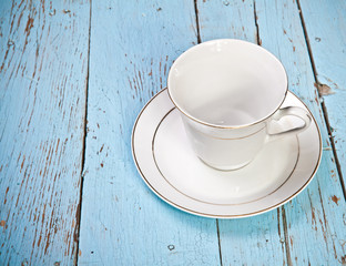 tea cup and saucer on wooden boards