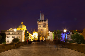 Fototapeta na wymiar Tourists near Charles bridge in Prague at night