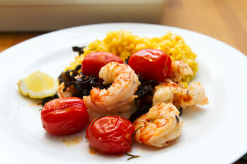 Prawns with risotto rice and tomatoes