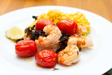 Prawns with risotto rice and tomatoes