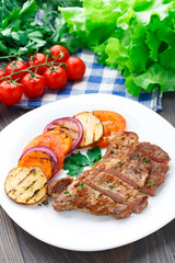 Steak with grilled vegetables on a plate