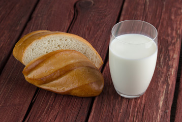 Glass of milk standing on old wooden table