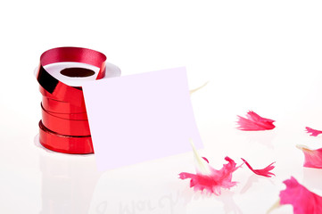 red ribbon and white card