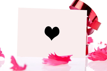 red ribbon and pink card whit heart