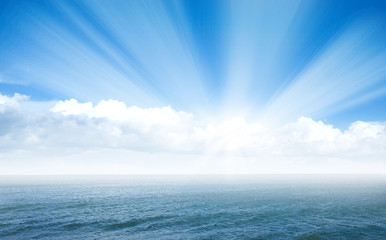 Blue sea with waves and sky with airy clouds