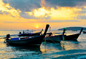 Traditional thai boats at sunset beach