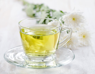 Cup of herbal tea and flowers