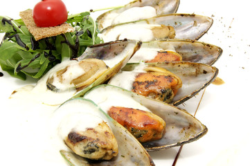 mussel sauce and greens on a white background