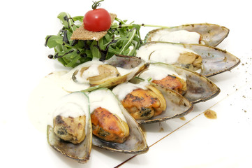 mussel sauce and greens on a white background