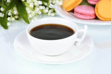 Coffee and macaroons isolated on white