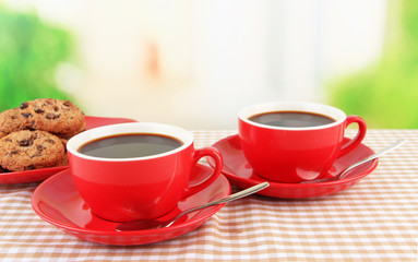 Red cups of strong coffee and cookies
