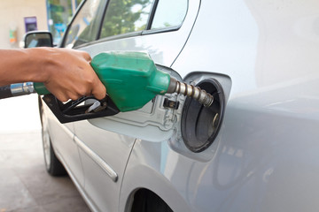 Fototapeta premium A man pumping gas in to the tank