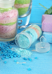 Obraz na płótnie Canvas Aromatic salts in glass bottles, on blue background
