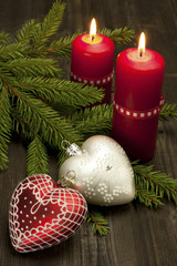 Christmas still life  with candles and heart form decoration