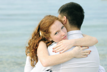 Fototapeta na wymiar beautiful young couple in love near the sea