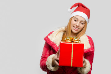 Beautiful red hair woman holding a big Christmas present