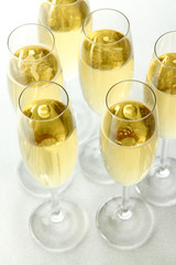 Glasses with champagne on shiny background