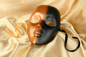 Mask on gold fabric background