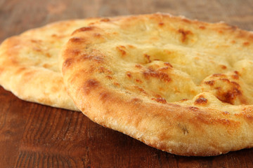 Pita breads on wooden background