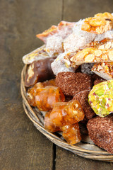 Tasty oriental sweets, on grey wooden background