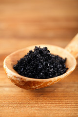 Hawaiian Black lava sea salt in rustic wooden spoon