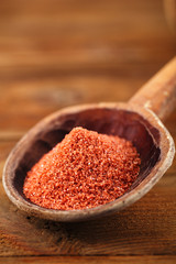 Red Crystal Rock salt in rustic wooden spoon