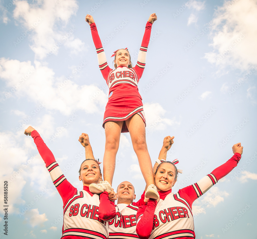 Wall mural Cheerleaders - Team with male Coach