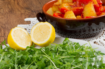 red peppers, potatoes and green salad called rucola