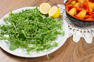red peppers, potatoes and green salad called rucola