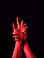 Red demonic hands with black nails, real body-art