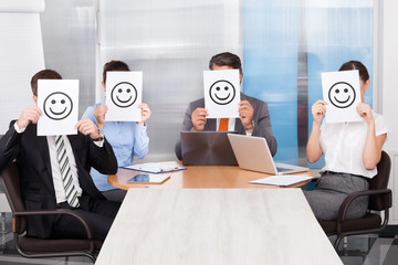 Businesspeople Holding Smiley Icon