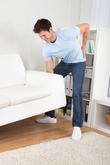 Man In Pain Lifting Couch