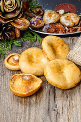 Saffron milk cap mushrooms on wooden table
