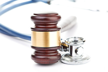 brown gavel and a medical stethoscope