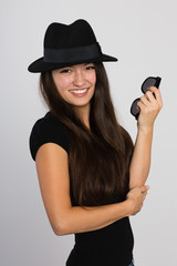 Beautiful smiling Asian young woman in a felt hat