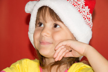 Smiling Little girl wearing santa hat