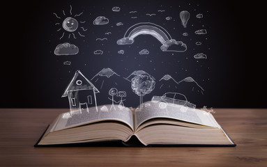 Open book with hand drawn landscape