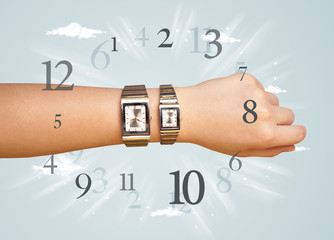 Hand with watch and numbers on the side comming out