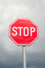 stop sign, cloudy sky
