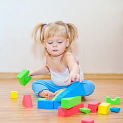 Little girl playing with cubes