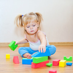 Little girl playing with cubes