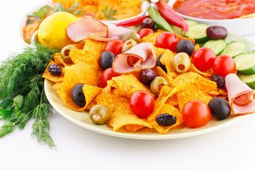 Nachos, olives, pork loin and vegetables
