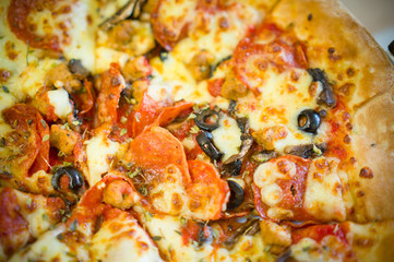 Fresh little italia pizza with pepperoni sausages and olives on