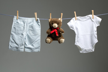 Baby boy clothes, a teddy bear on the clothesline