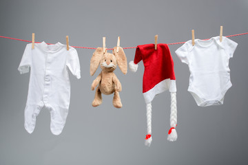 Baby clothes and santa hat on a clothesline