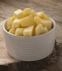 cut raw potatoes in bowl