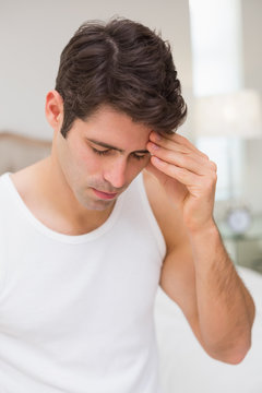 Man suffering from headache in bed