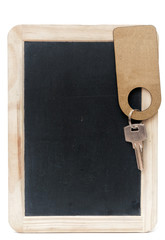 key with blank label on small school wooden blackboard