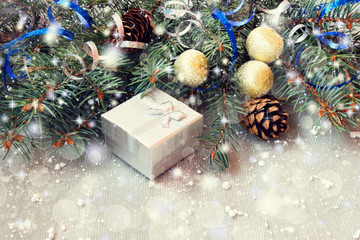 Fototapeta na wymiar silver gift box and decorated christmas tree twigs