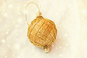 lovely golden christmas ball on a shiny soft yellow background - 58203522